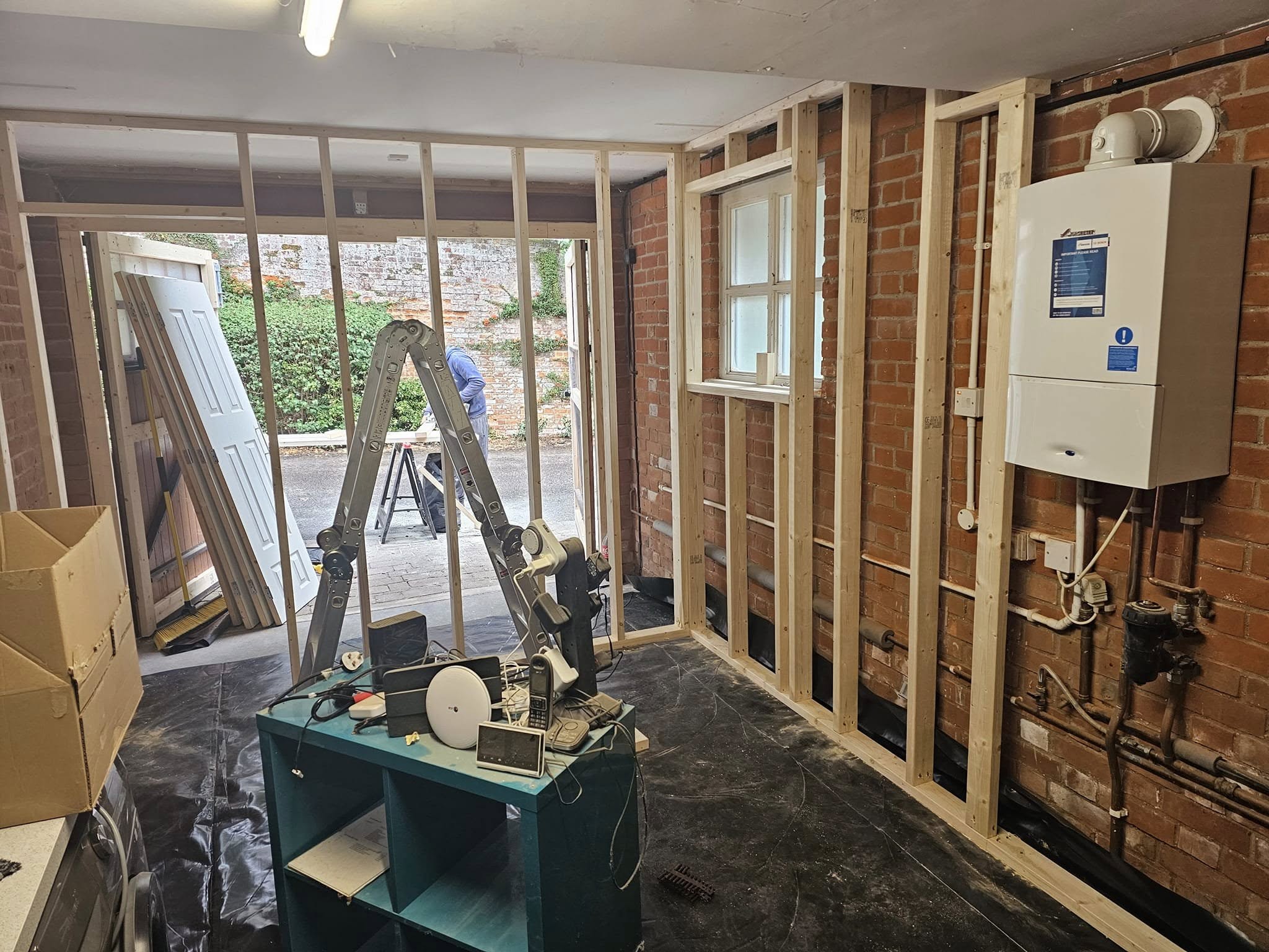 Completed gym and utility room with treadmill, wall-mounted TV and LVT flooring — Hertfordshire